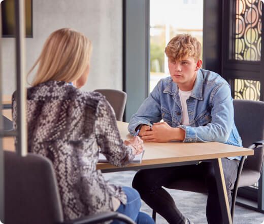 A member of staff meeting with a young person